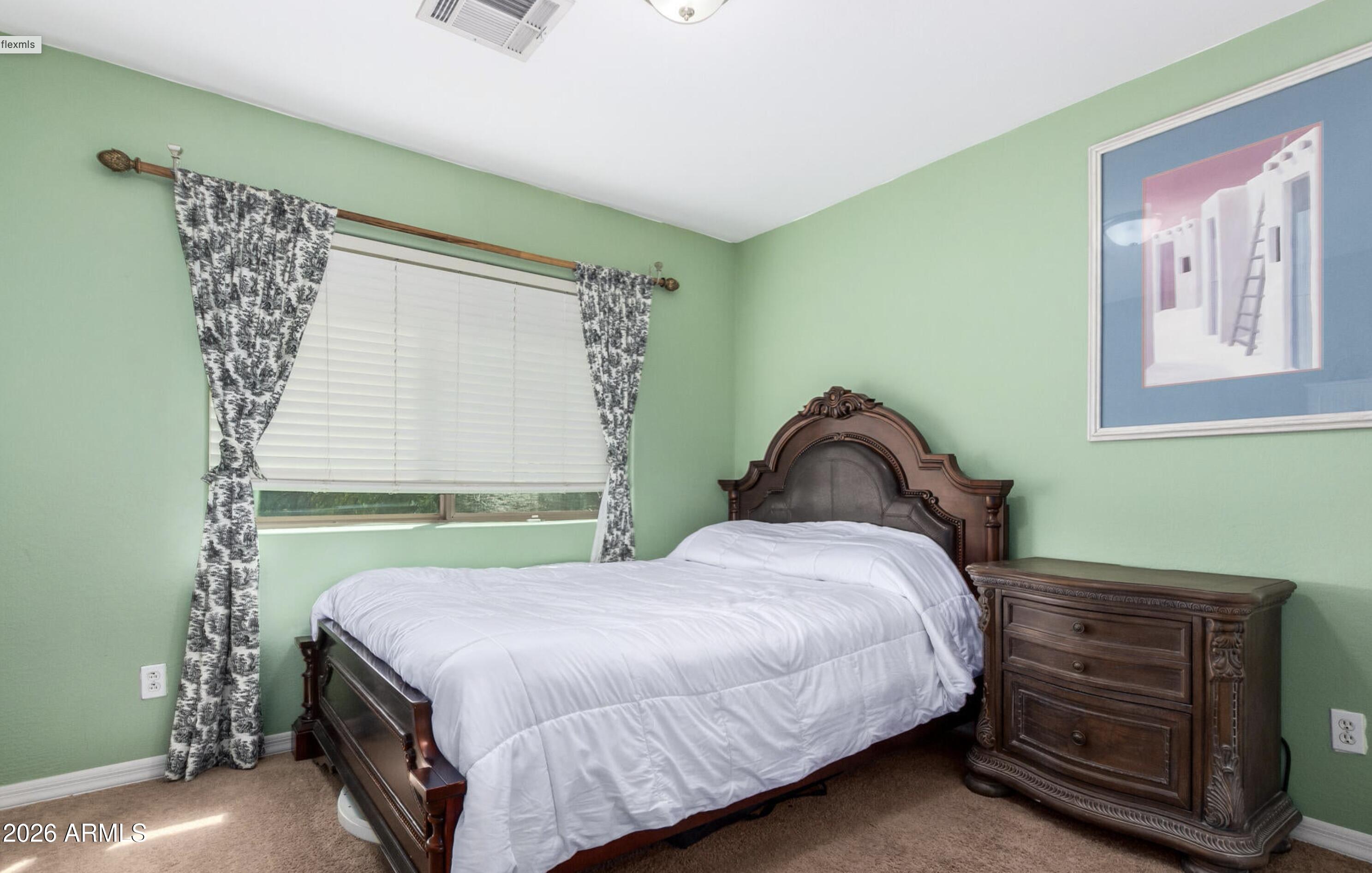 10225 West Camelback Road, Unit 12 Phoenix, AZ 85037 - Photo 13 of 19 a bedroom with a bed and a window