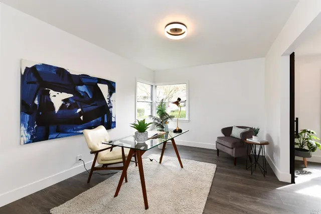 a workspace room with furniture and wooden floor