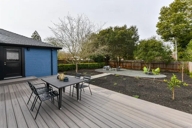 a view of a backyard with sitting area