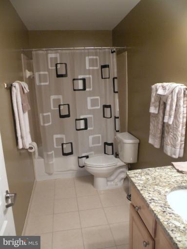 12000 Market Street, Unit 438 Reston, VA 20190 - Photo 11 of 13 a view of bathroom with a toilet sink and shower