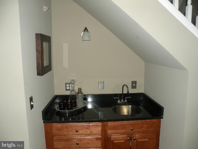 12000 Market Street, Unit 438 Reston, VA 20190 - Photo 3 of 13 a kitchen with granite countertop a sink and cabinets