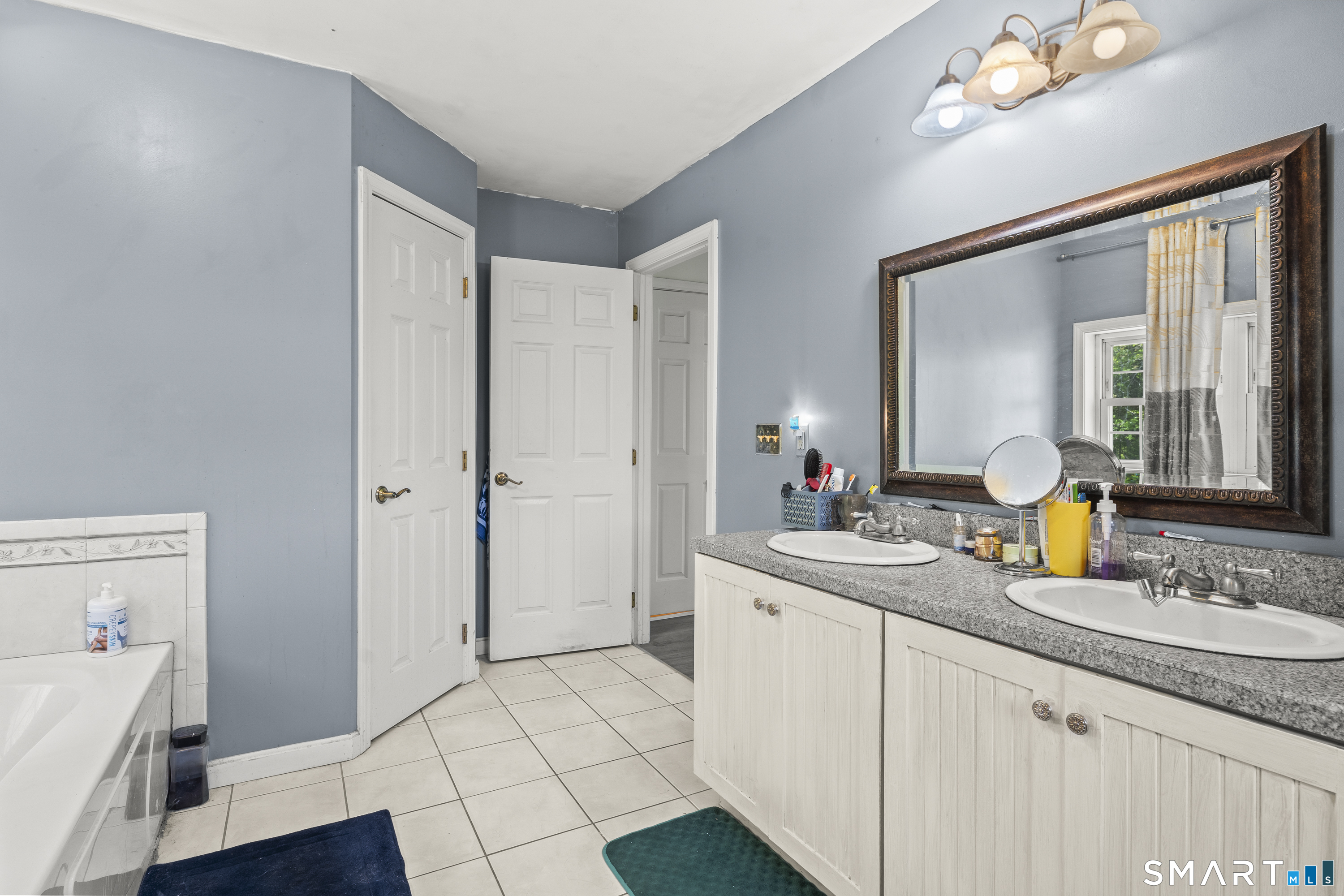 52 Middle Road Preston, CT 06365 - Photo 25 of 39 a spacious bathroom with a granite countertop sink a mirror and a shower