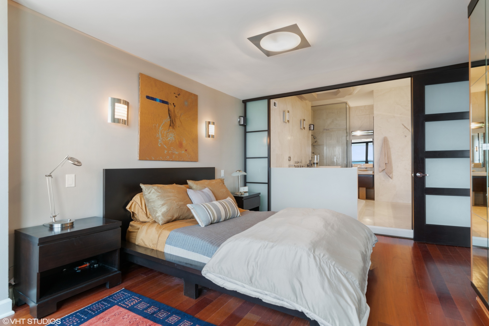 1030 North State Street, Unit 39B Chicago, IL 60610 - Photo 14 of 23 a spacious bedroom with a bed and wooden floor