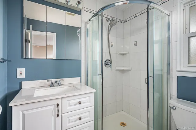 a bathroom with a shower sink and mirror