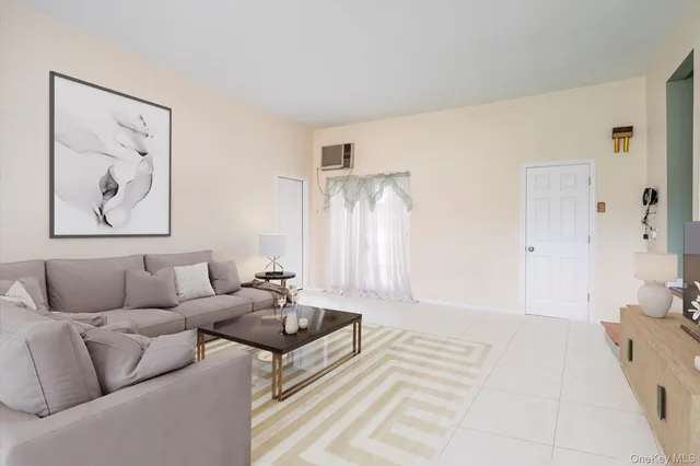 a living room with furniture and a painting on the wall