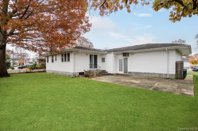 a front view of house with yard and trees