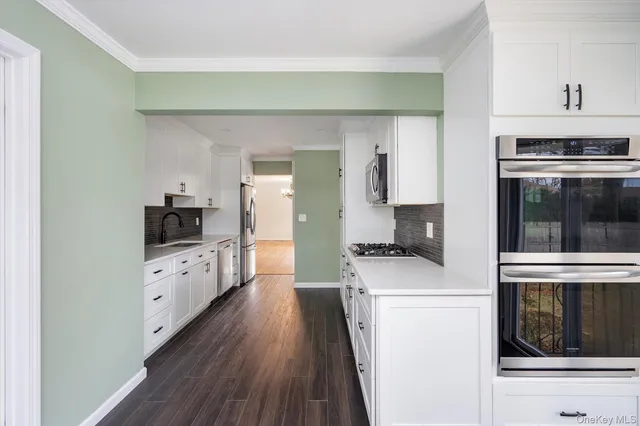 a kitchen with cabinets and stainless steel appliances