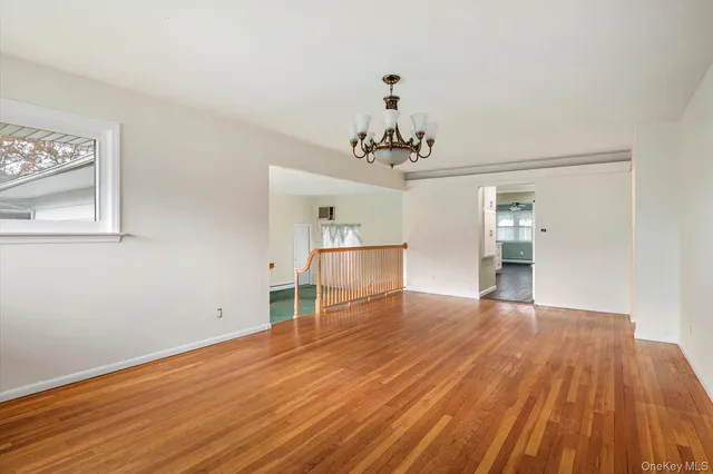 a view of a room with wooden floor and staircase