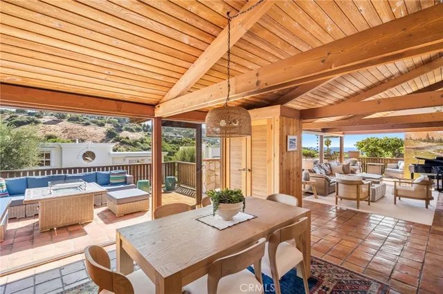 a view of a dining room with furniture large windows and wooden floor