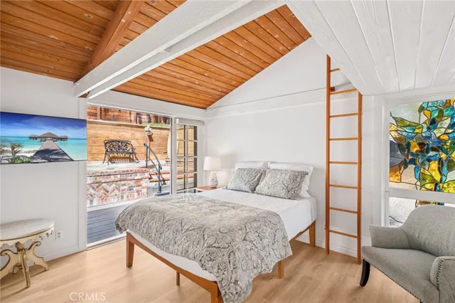 a bedroom with a bed and a dresser next to a window