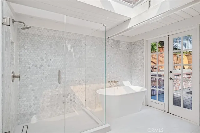 a bathroom with a bathtub and a shower