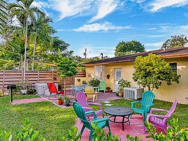 a view of a backyard with plants and a patio