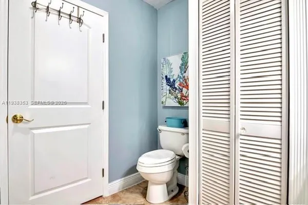 a bathroom with a toilet a sink and a window