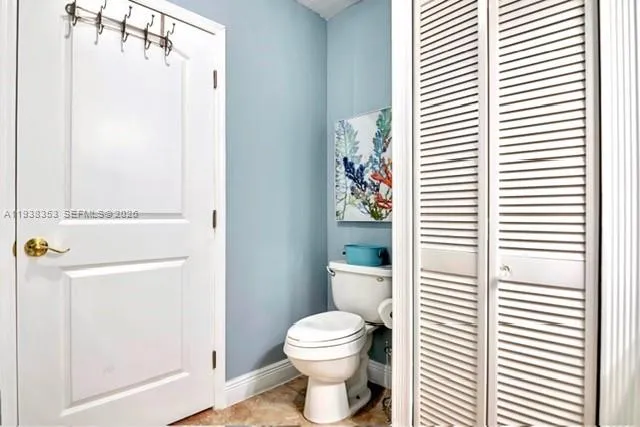 a bathroom with a toilet a sink and a window