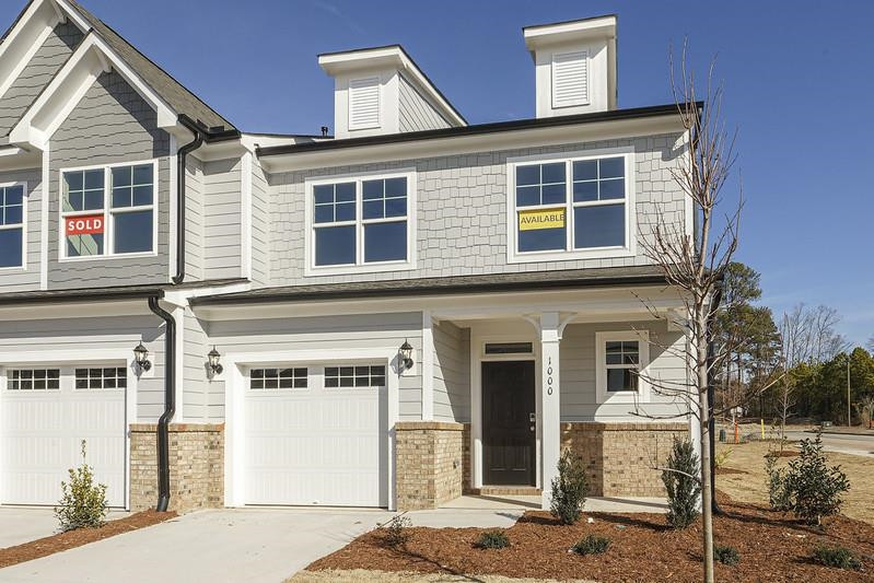 a front view of a house with a road