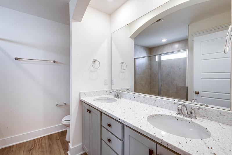 1000 Heartstone Way Durham, NC 27713 - Photo 11 of 35 a bathroom with a granite countertop sink a toilet and a mirror