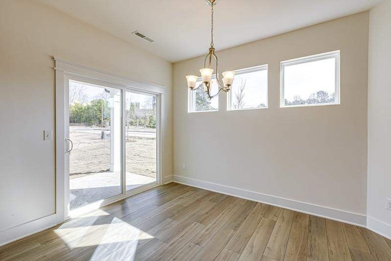 1000 Heartstone Way Durham, NC 27713 - Photo 6 of 35 a view of an empty room with wooden floor and a window