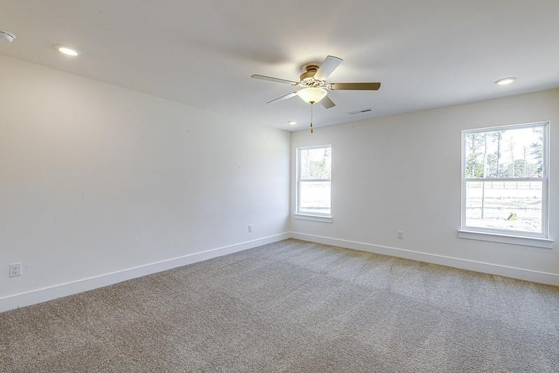 1000 Heartstone Way Durham, NC 27713 - Photo 9 of 35 an empty room with a window and a fan
