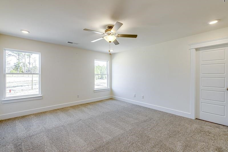 1000 Heartstone Way Durham, NC 27713 - Photo 10 of 35 an empty room with windows and fan