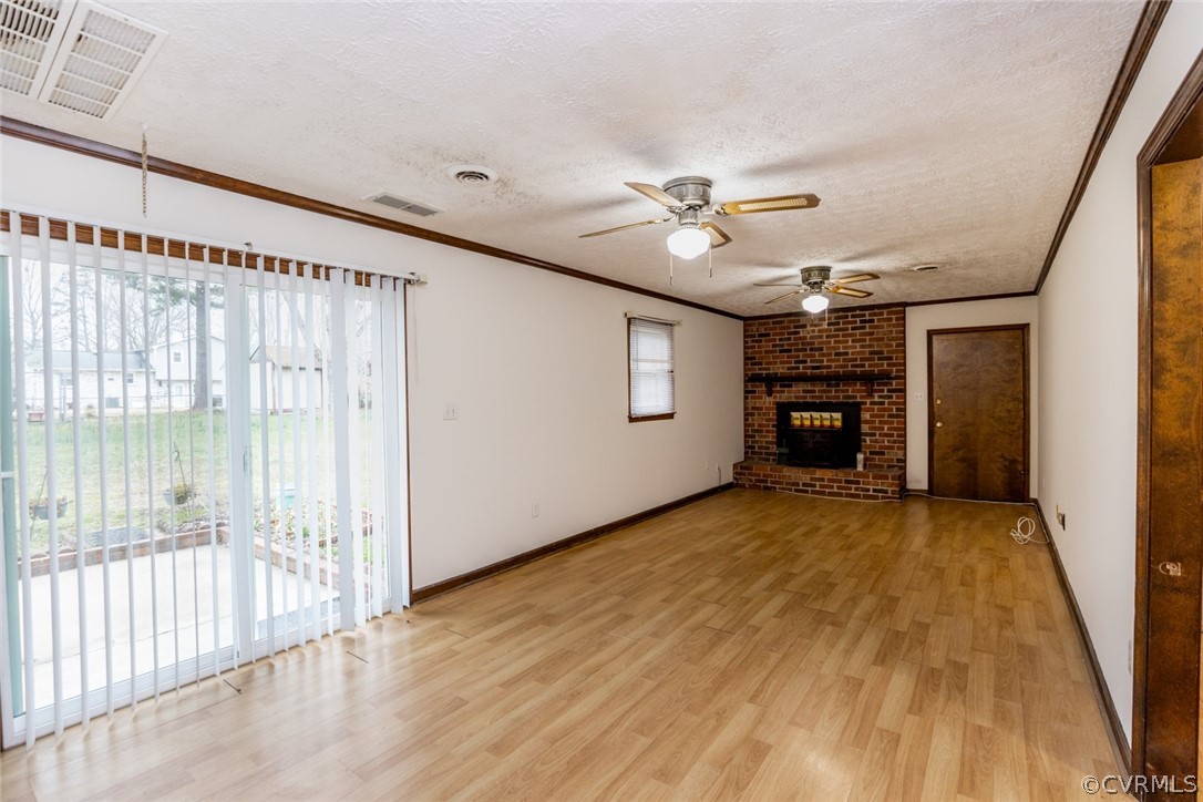 4636 Treely Road Chester, VA 23831 - Photo 25 of 48 a view of an empty room with a fireplace and a ceiling fan