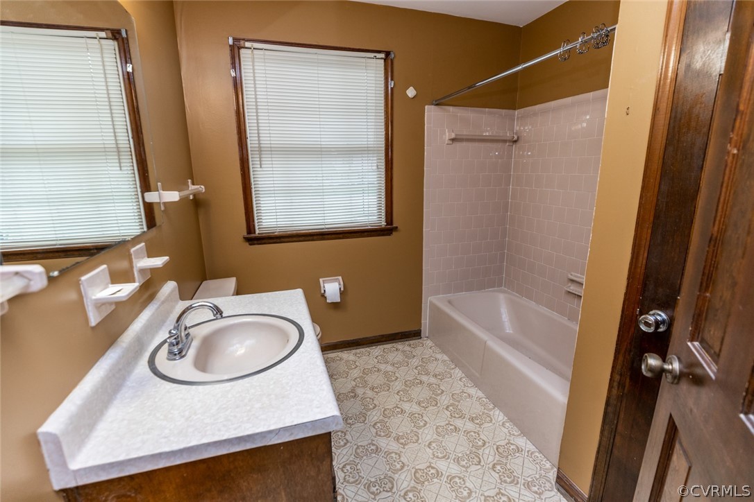 4636 Treely Road Chester, VA 23831 - Photo 27 of 48 a bathroom with a granite countertop sink a mirror and a bathtub