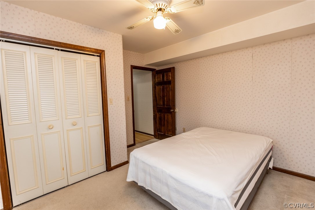 4636 Treely Road Chester, VA 23831 - Photo 30 of 48 a bedroom with a bed and a chandelier
