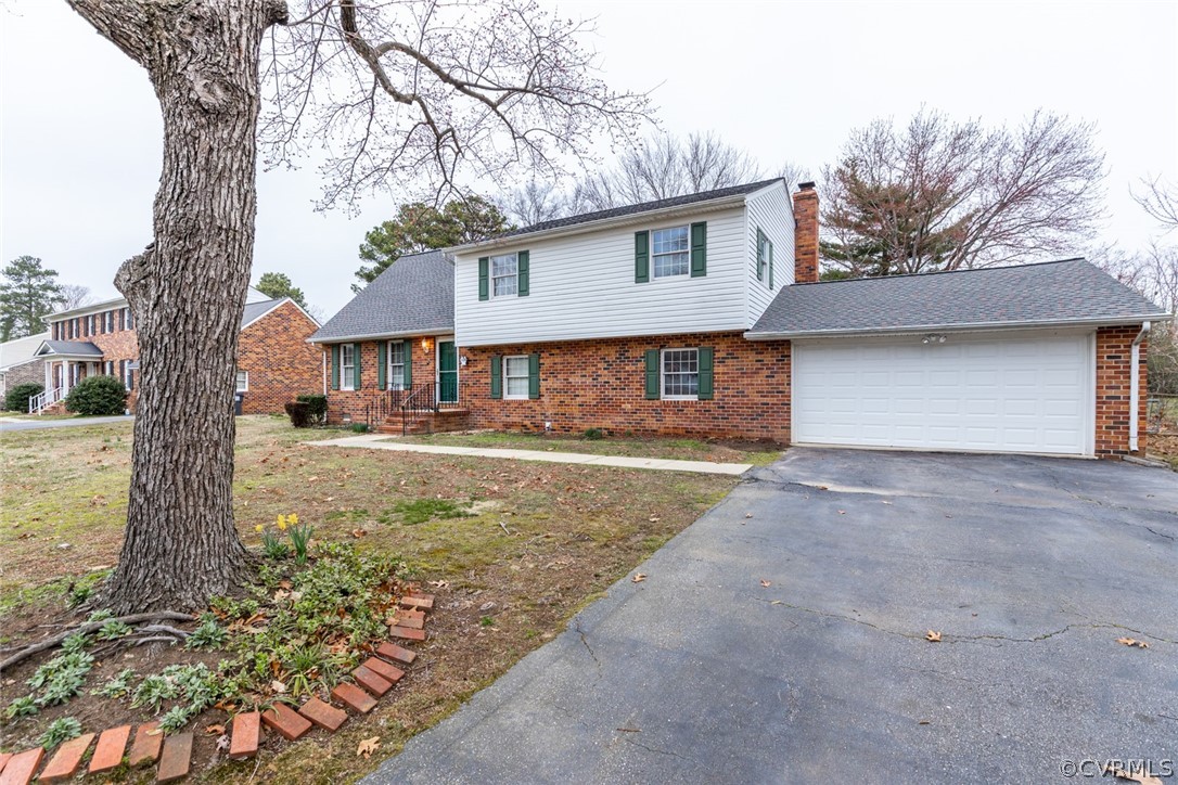 4636 Treely Road Chester, VA 23831 - Photo 3 of 48 a front view of a house with a yard and garage