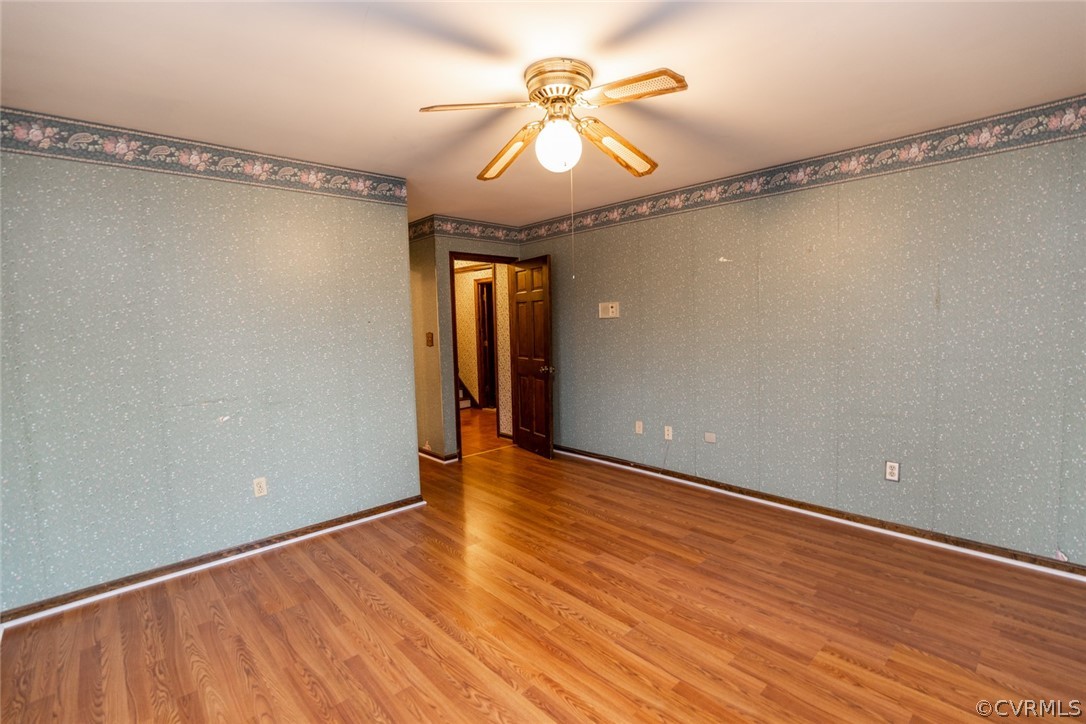 4636 Treely Road Chester, VA 23831 - Photo 37 of 48 a view of a room with wooden floor and a ceiling fan