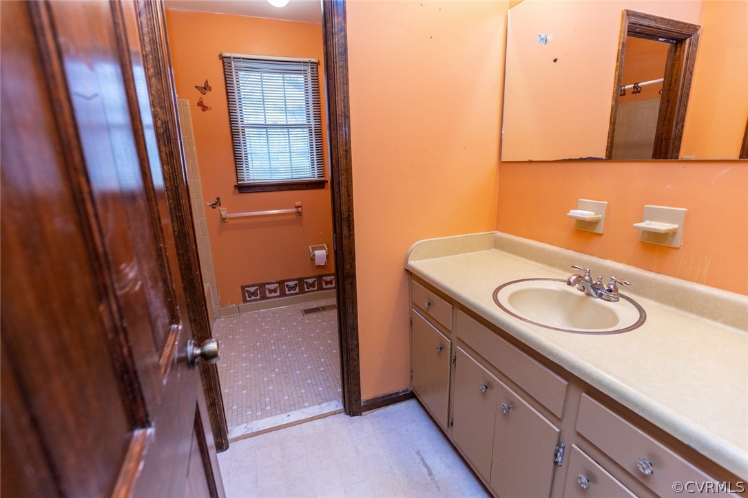 4636 Treely Road Chester, VA 23831 - Photo 44 of 48 a bathroom with a sink a mirror and vanity