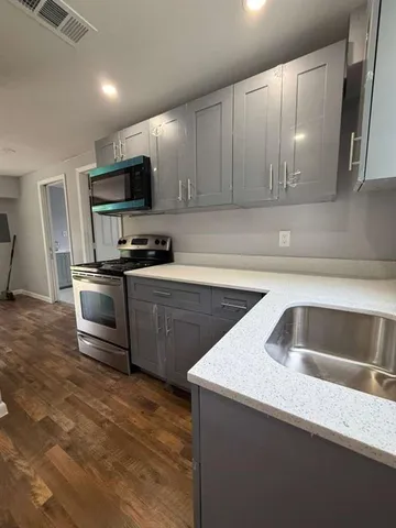 a kitchen that has a sink and a stove top oven