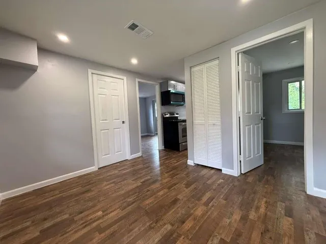 a view of a kitchen with a refrigerator and a sink