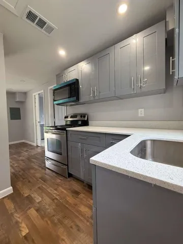 a kitchen with a sink a stove and refrigerator