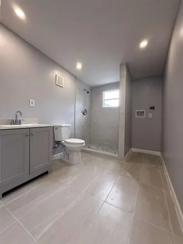 a bathroom with a sink a toilet and mirror
