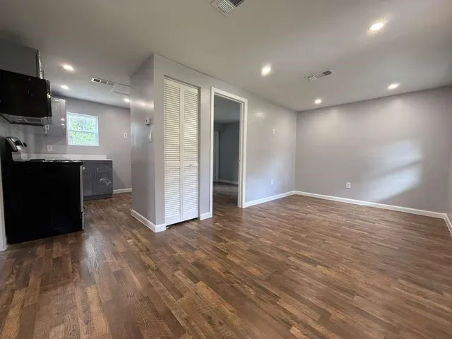 a view of a kitchen with wooden floor and a sink