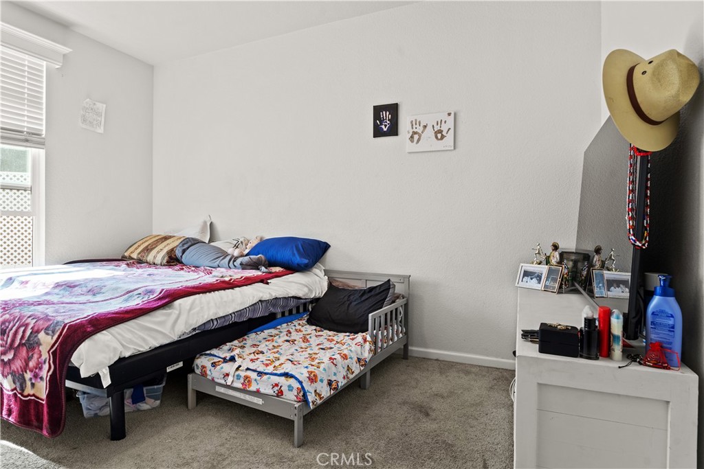 7101 Rosecrans Avenue, Unit 137 Paramount, CA 90723 - Photo 12 of 30 a bedroom with a bed and cabinets