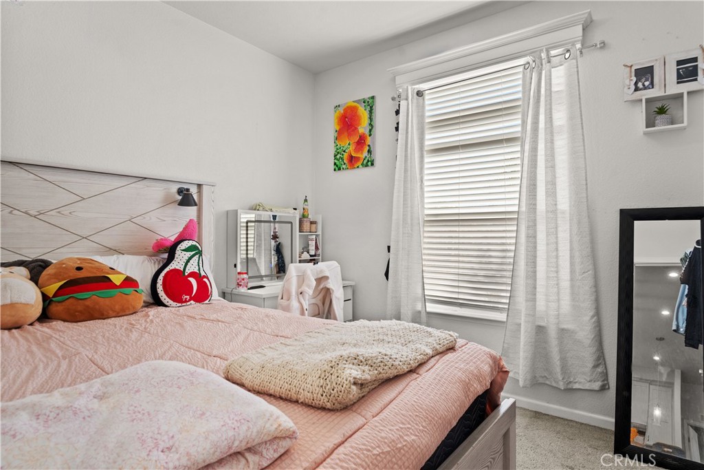 7101 Rosecrans Avenue, Unit 137 Paramount, CA 90723 - Photo 13 of 30 a bedroom with a bed and a painting on the wall