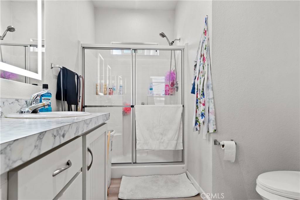 7101 Rosecrans Avenue, Unit 137 Paramount, CA 90723 - Photo 14 of 30 a bathroom with a sink vanity mirror and toilet