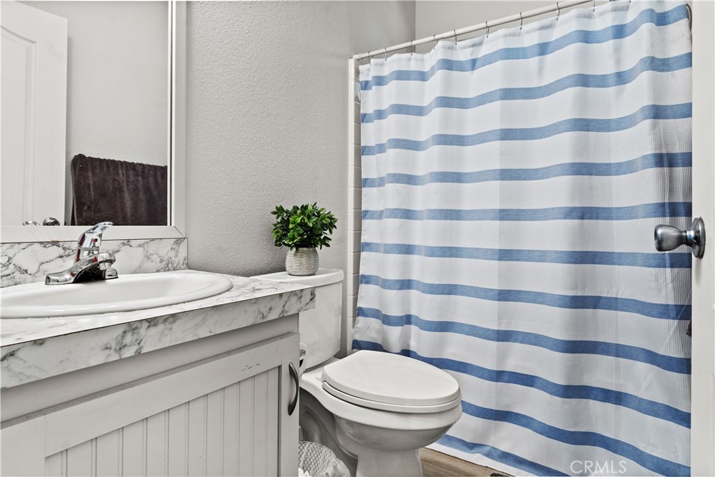 7101 Rosecrans Avenue, Unit 137 Paramount, CA 90723 - Photo 16 of 30 a bathroom with a sink a toilet a shower and a mirror