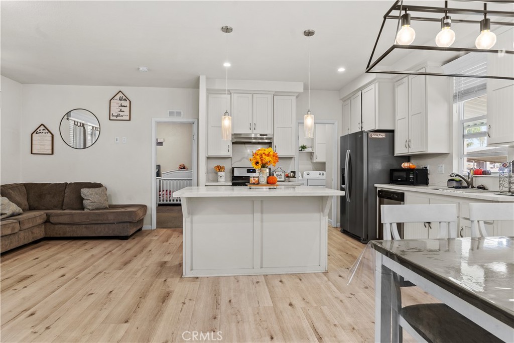 7101 Rosecrans Avenue, Unit 137 Paramount, CA 90723 - Photo 4 of 30 a kitchen with stainless steel appliances a refrigerator and a stove top oven