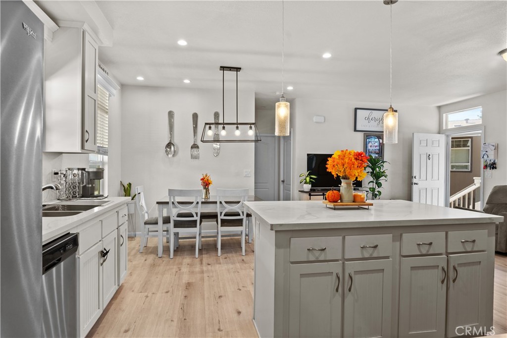 7101 Rosecrans Avenue, Unit 137 Paramount, CA 90723 - Photo 7 of 30 a kitchen with stainless steel appliances kitchen island granite countertop a sink and cabinets