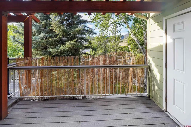 a kitchen with stainless steel appliances granite countertop a refrigerator a sink a stove and blue cabinets with wooden floor