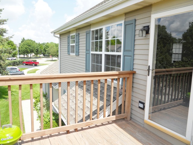 1303 Providence Circle, Unit 1303 Elgin, IL 60120 - Photo 16 of 16 a view of a balcony with wooden floor and fence