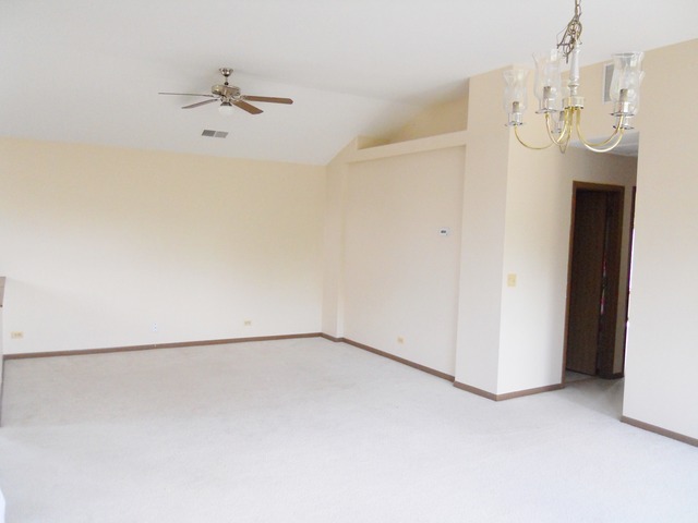 1303 Providence Circle, Unit 1303 Elgin, IL 60120 - Photo 5 of 16 a view of an empty room with a chandelier fan