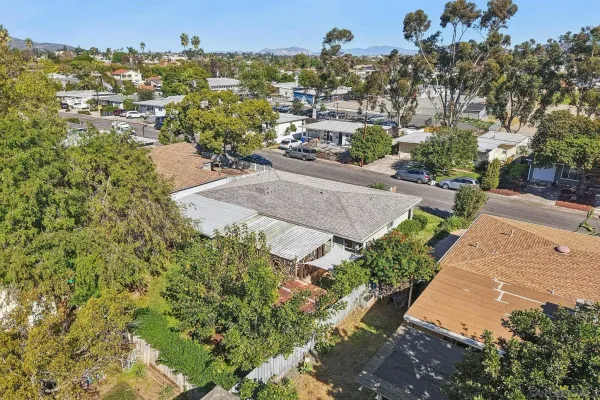 an aerial view of residential houses with outdoor space and street view