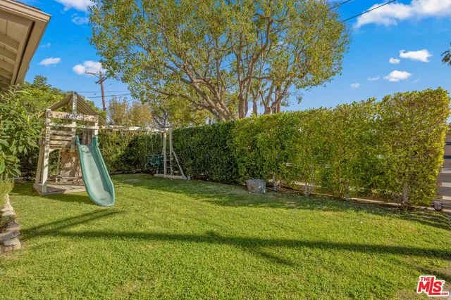 a view of a backyard with swimming pool