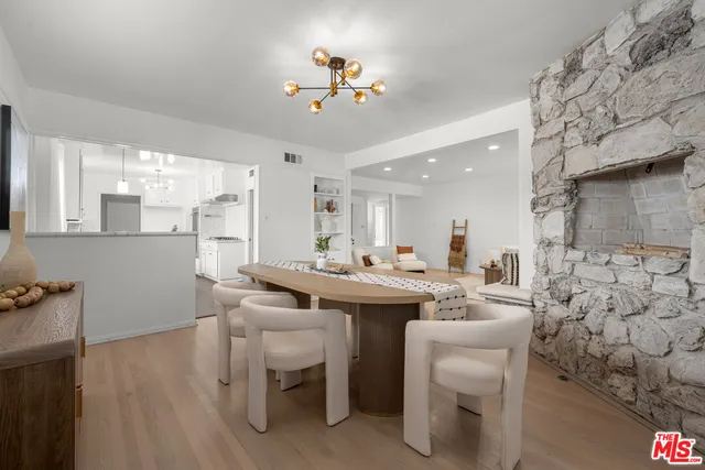 a kitchen with a sink cabinets and wooden floor