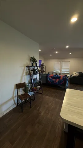 a view of a room with furniture and wooden floor