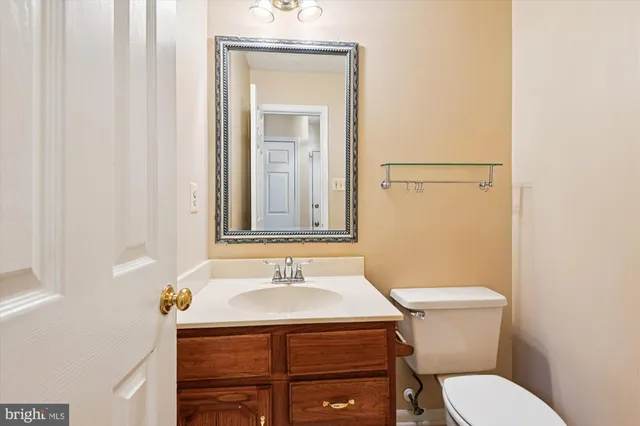 a bathroom with a sink toilet and mirror