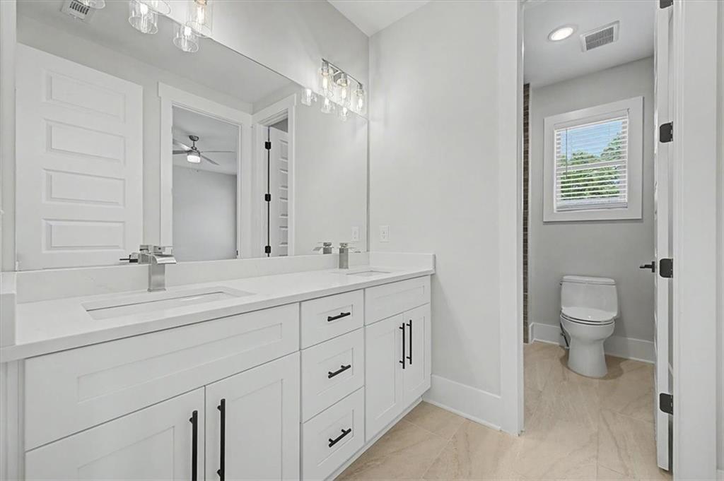 217 Laura Lake Road Marietta, GA 30066 - Photo 45 of 54 a bathroom with double vanity sink a toilet and a mirror