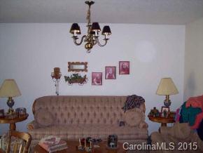 104 Hunters Trail Mill Spring Tryon, NC 28782 - Photo 3 of 4 a bedroom with a bed and chandelier